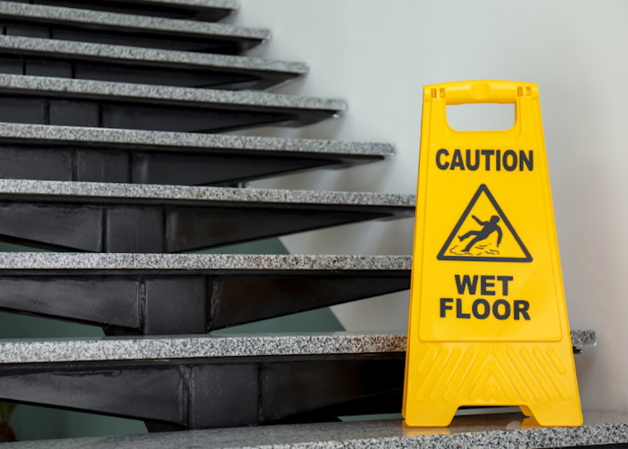 wet floor sign on stairs